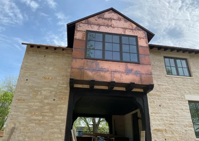Copper metal panel facade on a stone building for Skylight Installation in Hughson